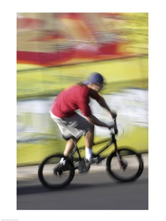 Framed Side profile of a teenage boy performing a stunt on a bicycle Print