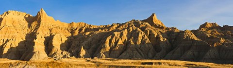 Framed Sculpted sandstone spires in golden light, Saddle Pass Trail, Badlands National Park, South Dakota, USA Print
