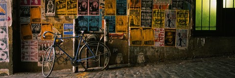Framed Bicycle leaning against a wall with posters in an alley, Post Alley, Seattle, Washington State, USA Print