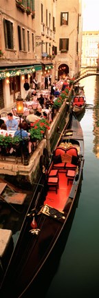 Framed Gondolas moored outside of a cafe, Venice, Italy Print