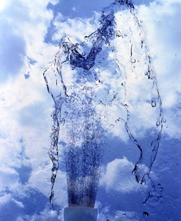 Framed Slow motion geyser of water rising through blue sky and clouds Print