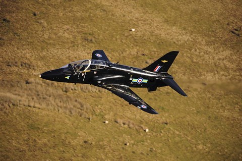 Framed Hawk T1 trainer aircraft of the Royal Air Force flying over barren terrain North Wales Print
