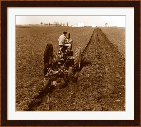 Framed USA, Pennsylvania, Farmer on Tractor Plowing Field Print
