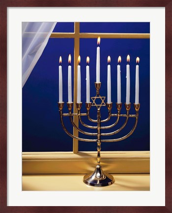 Framed Close-up of burning candles on a menorah at a window Print