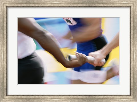 Framed Mid section view of runners exchanging baton at a relay race Print