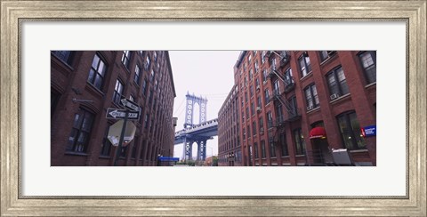 Framed Low angle view of a suspension bridge viewed through buildings, Manhattan Bridge, Brooklyn, New York City, New York State, USA Print