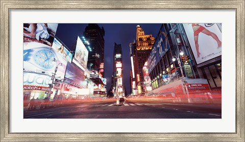 Framed Low angle view of sign boards lit up at night, Times Square, New York City, New York, USA Print