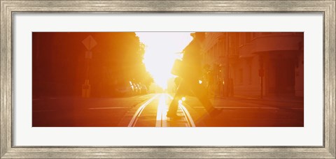 Framed Side profile of a person crossing the cable car tracks at sunset, San Francisco, California, USA Print