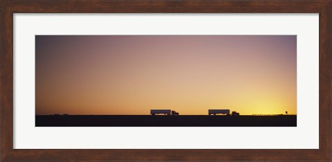 Framed Silhouette of two trucks moving on a highway, Interstate 5, California, USA Print