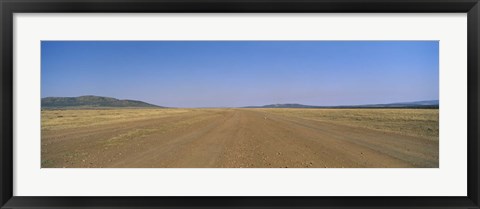 Framed Dirt road passing through a landscape, Masai Mara National Reserve, Great Rift Valley, Kenya Print