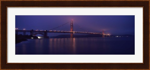 Framed Suspension bridge lit up at dawn viewed from fishing pier, Golden Gate Bridge, San Francisco Bay, San Francisco, California, USA Print