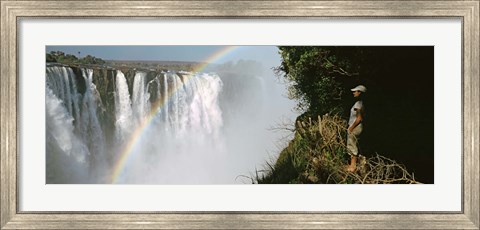 Framed Woman looking at a rainbow over the Victoria Falls, Zimbabwe Print