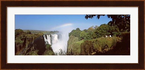 Framed Tourists at a viewing point looking at the rainbow formed over Victoria Falls, Zimbabwe Print
