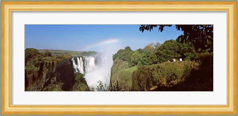 Framed Tourists at a viewing point looking at the rainbow formed over Victoria Falls, Zimbabwe Print