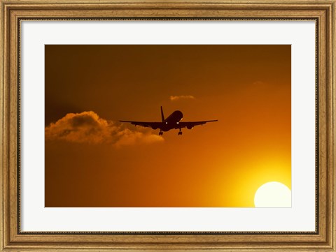 Framed Silhouette of airliner in golden sunset Print