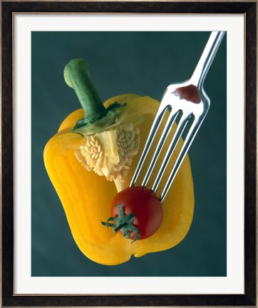 Framed Close up of half yellow pepper with cherry tomato in center on fork tines Print