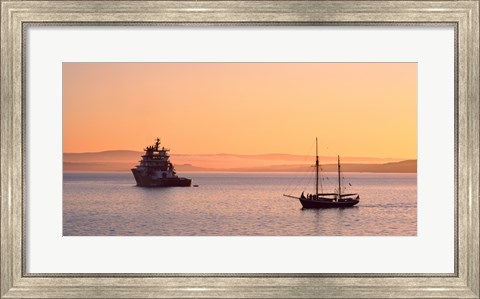 Framed Tugboat and a tall ship in the Baie de Douarnenez at sunrise, Finistere, Brittany, France Print