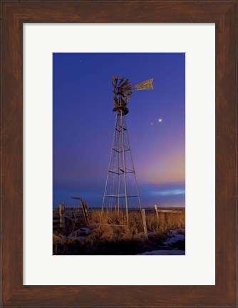 Framed Venus and Jupiter are visible behind an old farm water pump windmill, Alberta, Canada Print