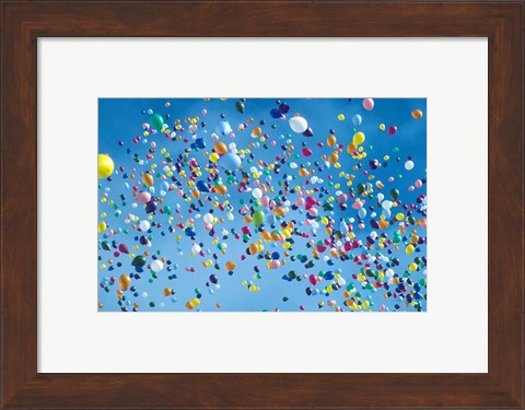 Framed Holiday balloons drifting into the sky Print