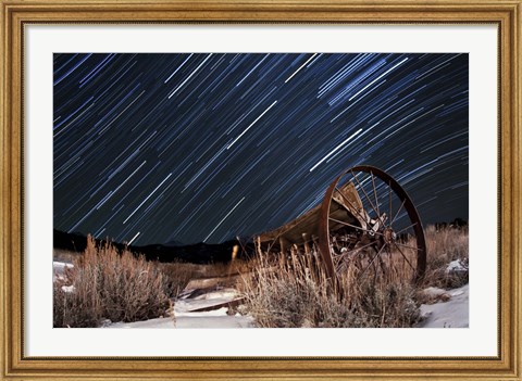 Framed Abandoned farm equipment against a backdrop of star trails Print