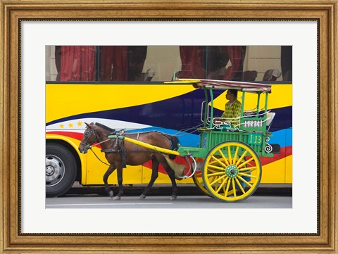 Framed Horse cart walk by colorfully painted bus, Manila, Philippines Print