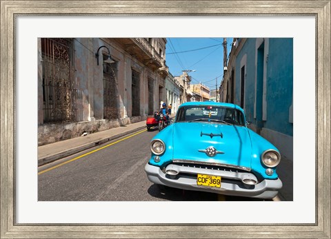 Framed Cuba, Camaquey, Oldsmobile car and buildings Print