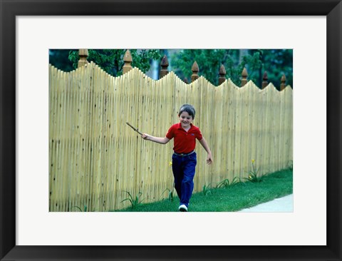 Framed 1980s Smiling Boy Running Along Sidewalk Print