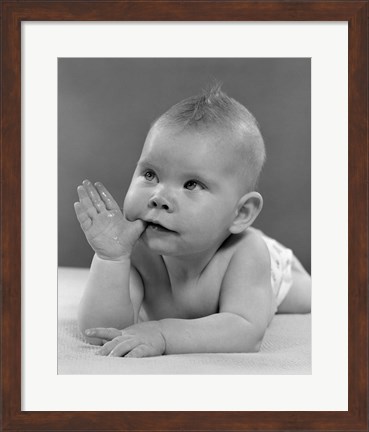 Framed 1950s Baby Lying On Stomach With Thumb In Mouth Print