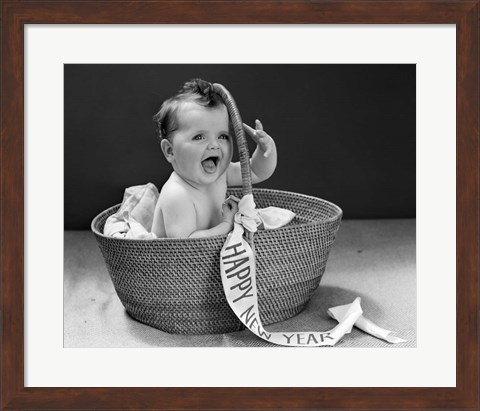 Framed 1940s Baby In Wicker Basket With Happy New Year Banner Print