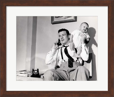 Framed 1950s Father Holding Baby While On The Phone Print