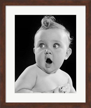Framed 1950s Wide Eyed Baby Holding Toy Rattle Print