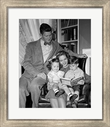 Framed 1940s Father Watching  Mother Reading To Son And Daughter Print