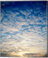 Low angle view of sunrise seen through clouds Fine Art Print