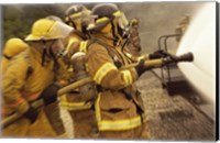 Side profile of a group of firefighters holding water hoses Fine Art Print