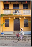 Person riding a bicycle in front of a cafe, Hoi An, Vietnam Fine Art Print
