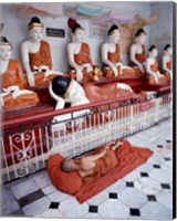 Monk Sleeping in Front of Buddha Statues Fine Art Print