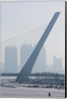 Songhuajiang Highway Bridge across the frozen Songhua River with buildings in the background, Harbin, China Fine Art Print