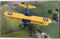 Boeing Stearman Model 75 Kaydet flying over fields Fine Art Print