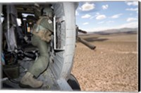 A HH-60G Pave Hawk gunner fires his GAU-17 machine gun Fine Art Print