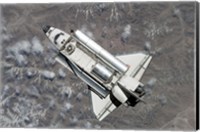 Aerial view of Space Shuttle Discovery over Earth as it approaches the International Space Station Fine Art Print