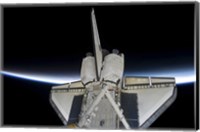 Space Shuttle Discovery Intersecting the Thin line of Earth's Atmosphere, while Docked with the International Space Station Fine Art Print
