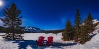 Red Chairs Under a Moonlit Winter Sky at Two Jack Lake Fine Art Print