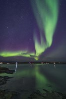 A Curtain of Aurora Sweeps Over the Houseboats Moored On Yellowknife Bay Fine Art Print