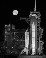 Space Shuttle Discovery Sits Atop the Launch Pad With a Full Moon in Background Framed Print