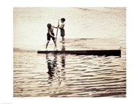 Two boys standing on a wooden platform in a lake Fine Art Print