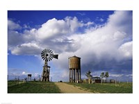 Low angle view of a water tower and an industrial windmill, 1880 Town, South Dakota, USA Fine Art Print