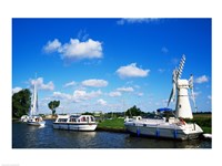 Boats moored near a traditional windmill, River Thurne, Norfolk Broads, Norfolk, England Fine Art Print