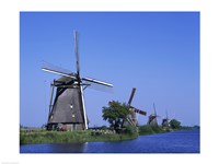 Windmills along a river, Kinderdike, Amsterdam, Netherlands Fine Art Print