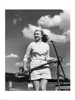 Young woman standing on boat, holding anchor Fine Art Print