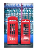 Two telephone booths near a grille, London, England Fine Art Print